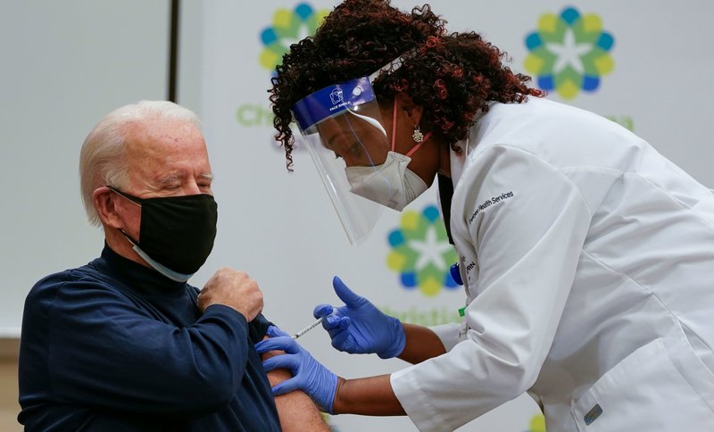 US President-elect Joe Biden receives a Covid-19 vaccination from Tabe Masa, Nurse Practitioner and Head of Employee Health Services, at the Christiana Care campus in Newark, Delaware on December 21, 2020. (Photo by Alex Edelman / AFP) (Photo by ALEX EDELMAN/AFP via Getty Images)